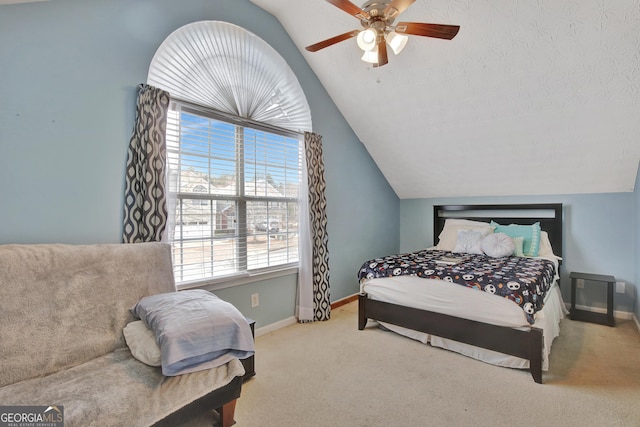 carpeted bedroom featuring baseboards, lofted ceiling, and a ceiling fan