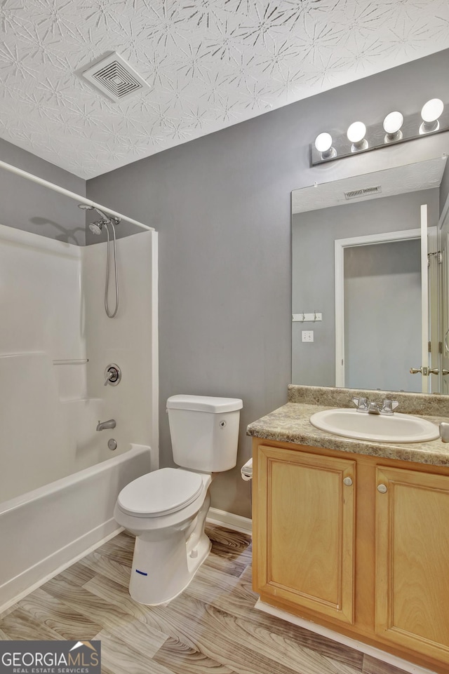 bathroom with visible vents, toilet, shower / washtub combination, and vanity