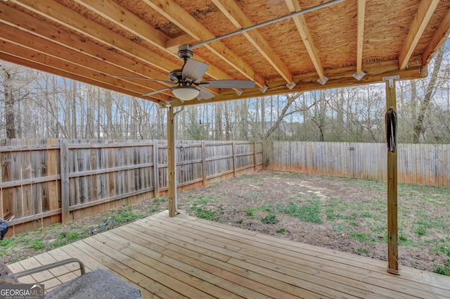 deck with a fenced backyard and ceiling fan