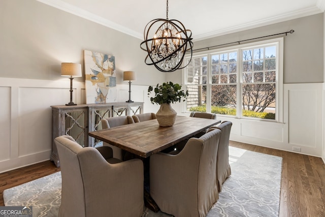 dining area featuring a decorative wall, a healthy amount of sunlight, and crown molding