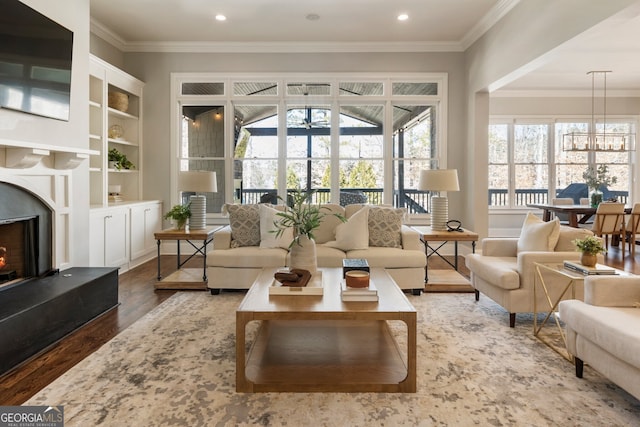 sunroom with an inviting chandelier and a premium fireplace