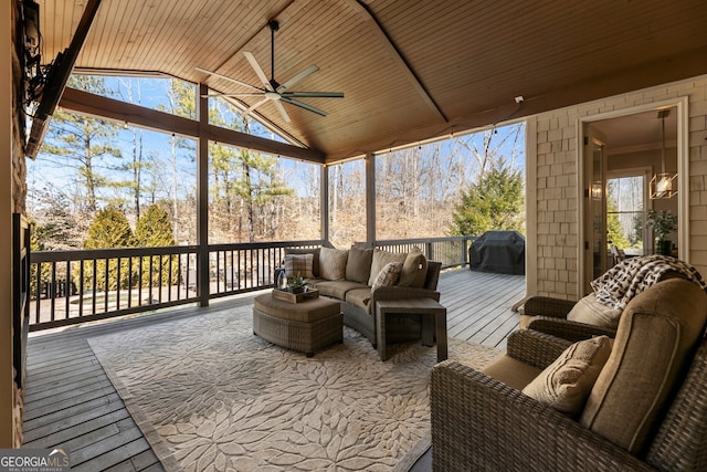 sunroom / solarium with wood ceiling, a ceiling fan, and vaulted ceiling