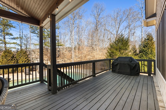 wooden deck featuring a grill