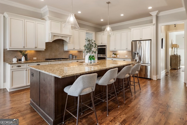 kitchen with dark wood-style floors, ornamental molding, a large island, white cabinets, and appliances with stainless steel finishes