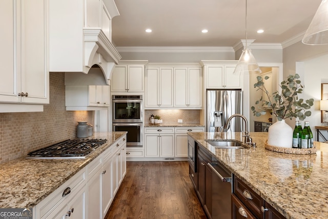 kitchen with a sink, appliances with stainless steel finishes, crown molding, and white cabinetry