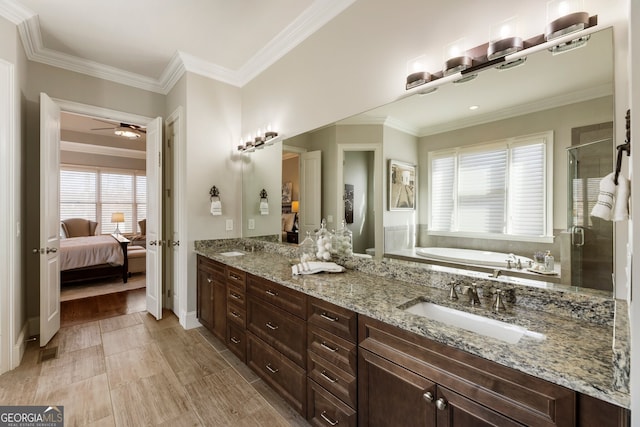 ensuite bathroom featuring a garden tub, a stall shower, a sink, crown molding, and double vanity