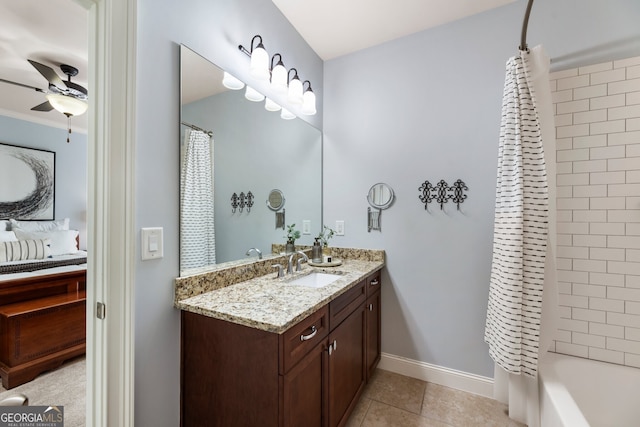 ensuite bathroom featuring tile patterned floors, ensuite bath, baseboards, ceiling fan, and vanity