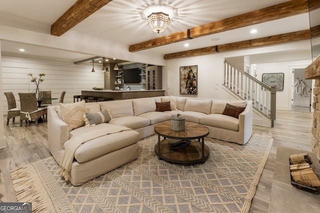 living room with stairway, recessed lighting, wood finished floors, and beamed ceiling