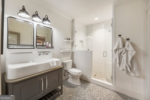 bathroom featuring vanity, recessed lighting, a shower stall, tile patterned floors, and toilet