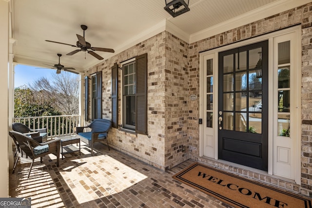 property entrance with brick siding, covered porch, and a ceiling fan