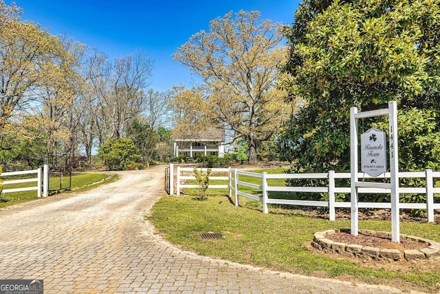 exterior space with decorative driveway and a gated entry