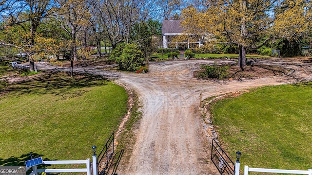 exterior space with a front yard, driveway, and fence