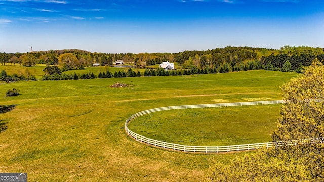 view of community with a rural view and a lawn