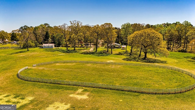 view of community with a rural view and a lawn