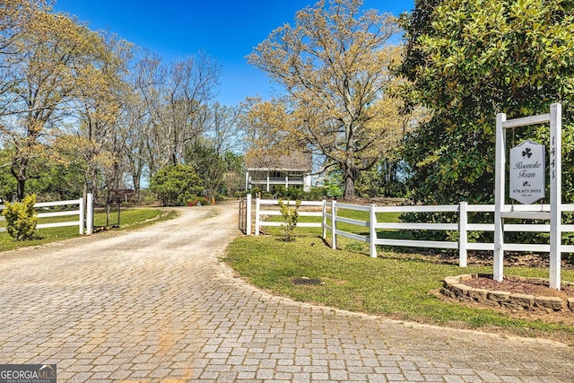 view of gate with a yard and fence