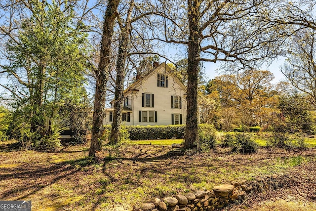 view of property exterior featuring a chimney