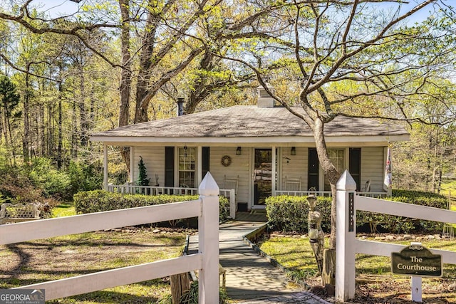 view of front of house with a fenced front yard and a porch