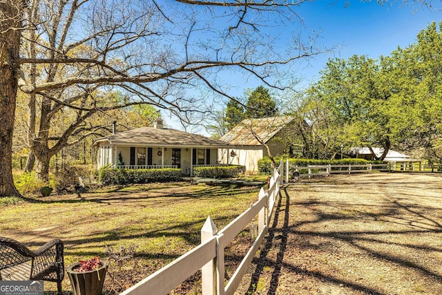 view of front of home with a front lawn, fence, and covered porch