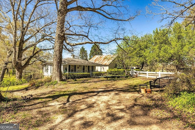 exterior space with a chimney and fence