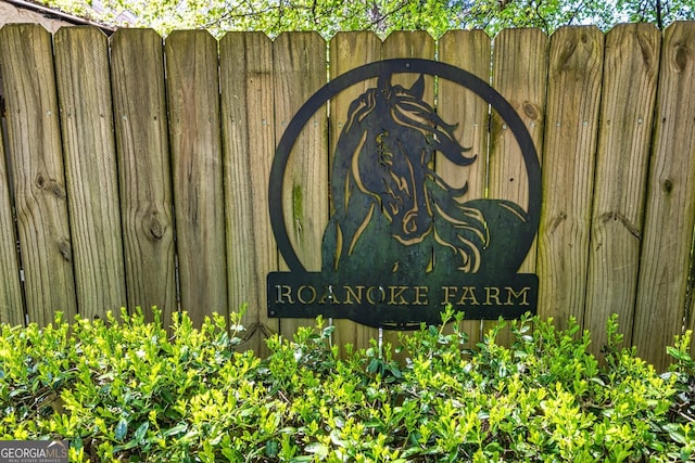 community sign featuring fence