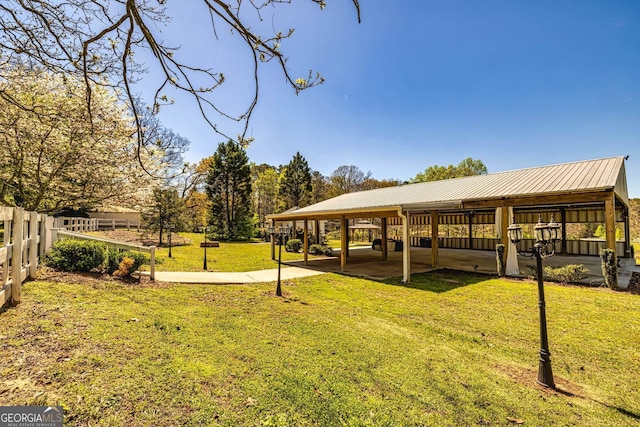 surrounding community with a yard and fence