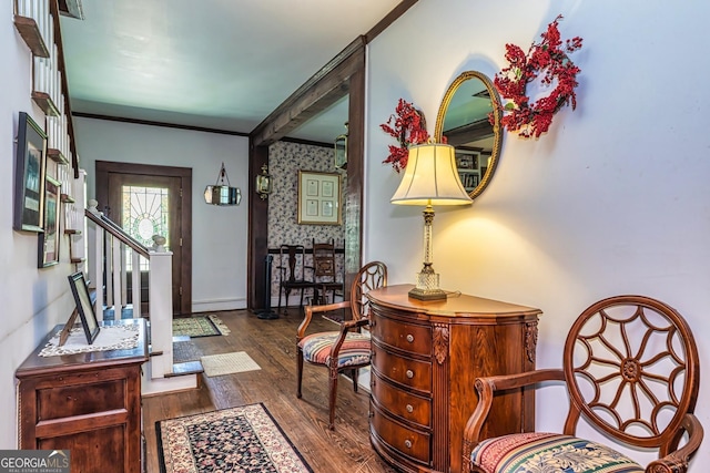 entrance foyer featuring stairway, wood finished floors, baseboards, wallpapered walls, and ornamental molding