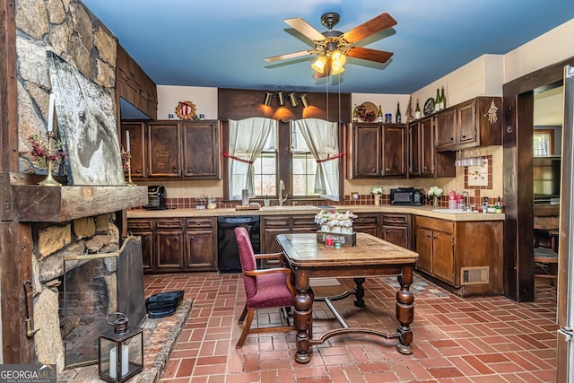 kitchen with visible vents, light countertops, brick floor, black appliances, and a sink