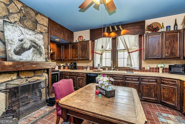 kitchen featuring a ceiling fan, a sink, black dishwasher, dark brown cabinets, and tile counters