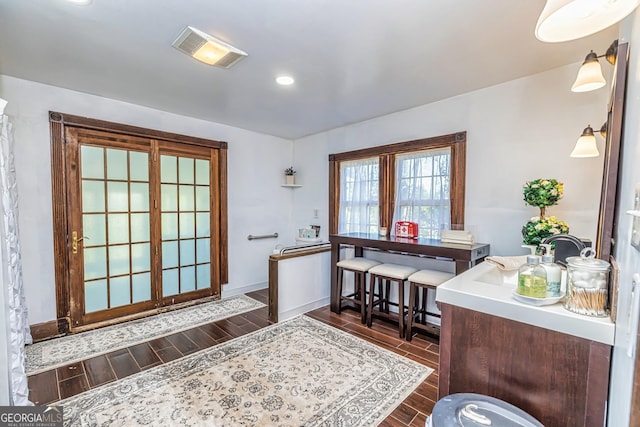 interior space with visible vents, recessed lighting, baseboards, and wood finish floors