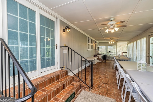 interior space with ceiling fan