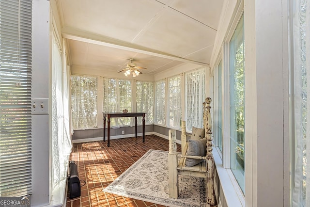 sunroom featuring a ceiling fan