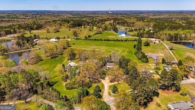 aerial view featuring a forest view and a water view