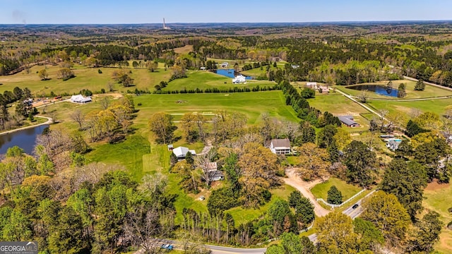 birds eye view of property featuring golf course view, a forest view, and a water view