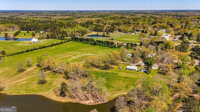 aerial view with a water view and a wooded view