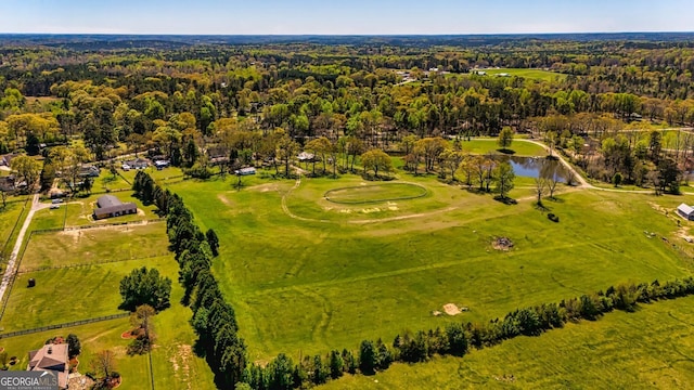 birds eye view of property featuring a view of trees and a water view