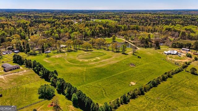 drone / aerial view with a wooded view