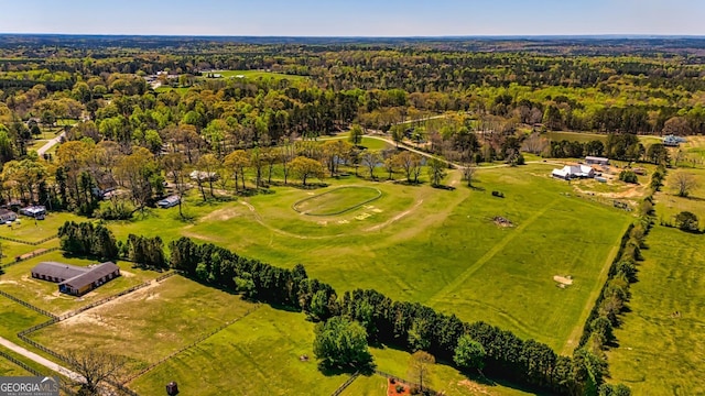 birds eye view of property featuring a forest view