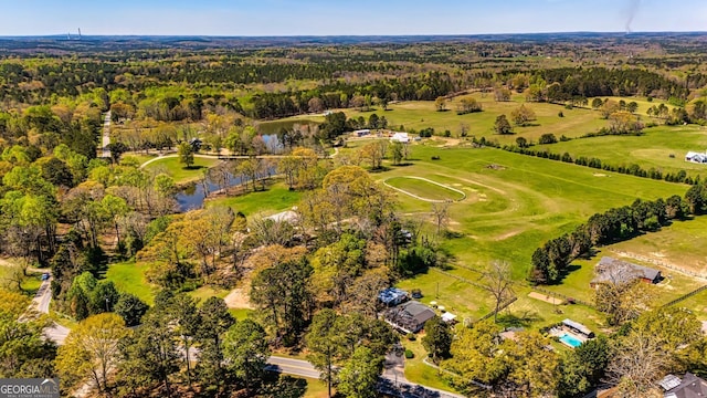 bird's eye view with a view of trees and a water view