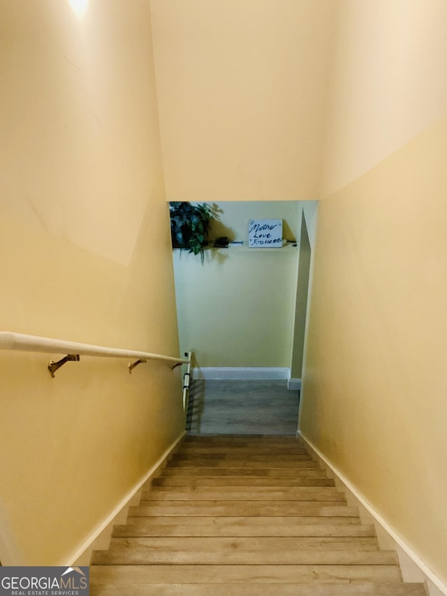 stairs featuring wood finished floors