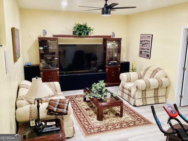 living area featuring wood finished floors and a ceiling fan