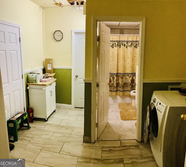 laundry area with cabinet space, hookup for a washing machine, and wainscoting