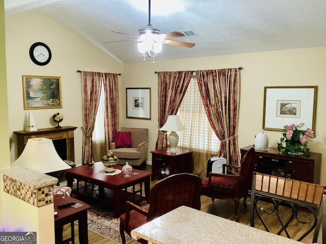 sitting room featuring lofted ceiling, wood finished floors, and ceiling fan