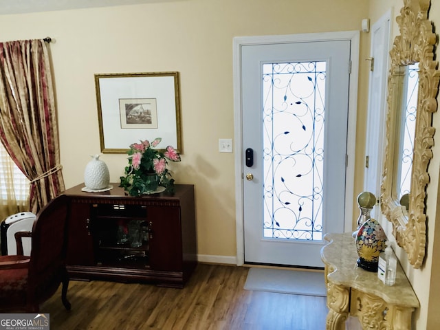 foyer entrance with wood finished floors and baseboards