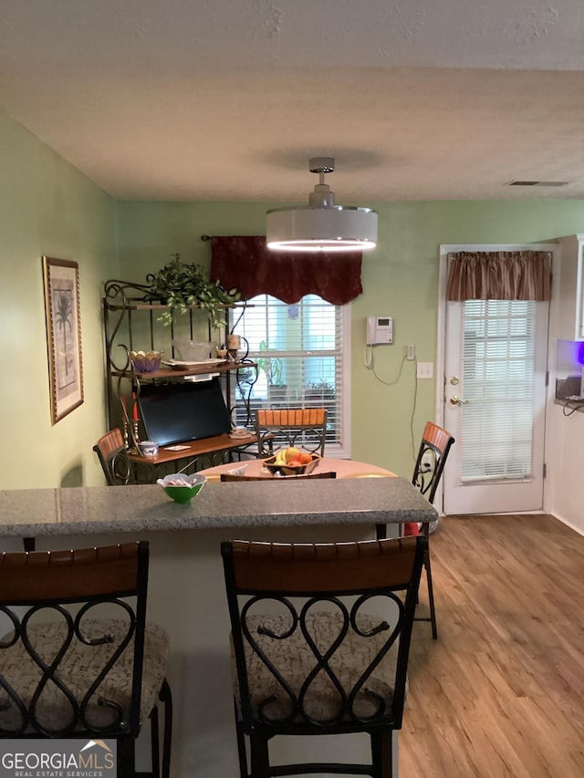 interior space with a breakfast bar and light wood finished floors