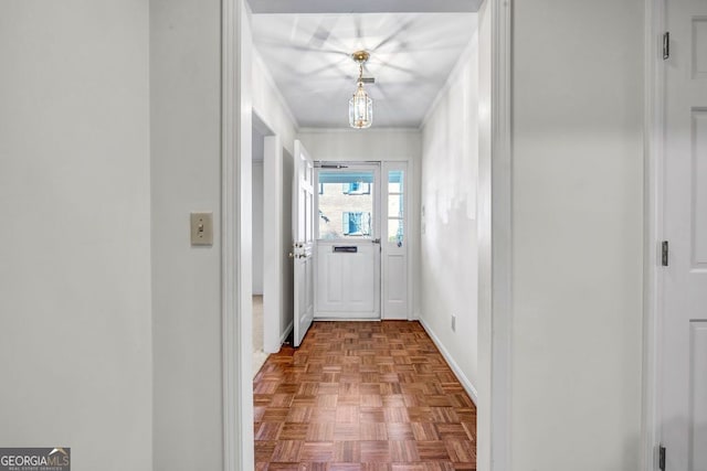 entryway featuring baseboards and crown molding