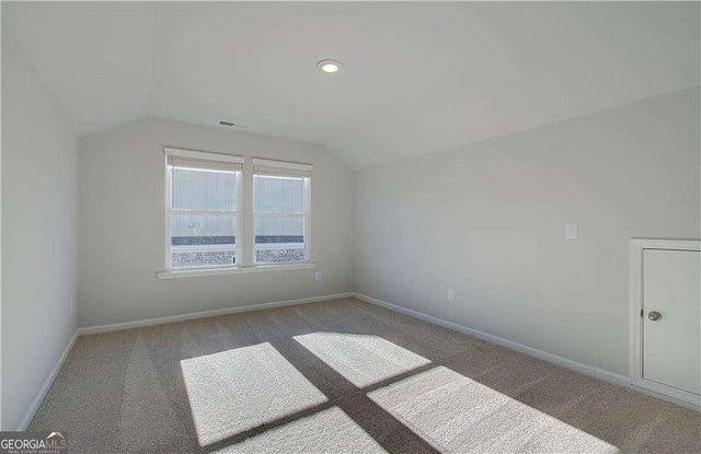 additional living space featuring visible vents, recessed lighting, carpet floors, baseboards, and vaulted ceiling