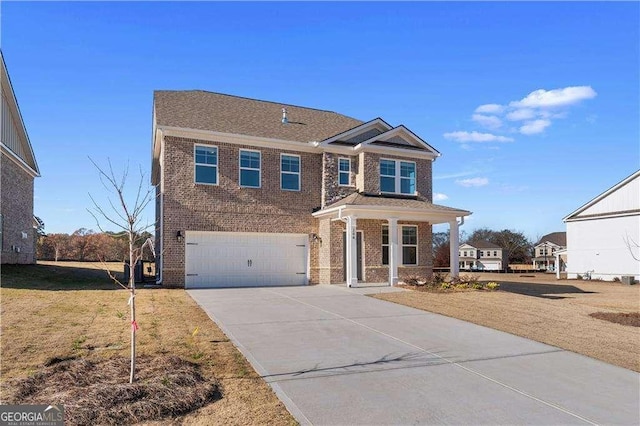 view of front of property featuring brick siding, driveway, a front lawn, and a garage