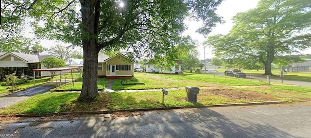 view of front of property with driveway and a detached carport