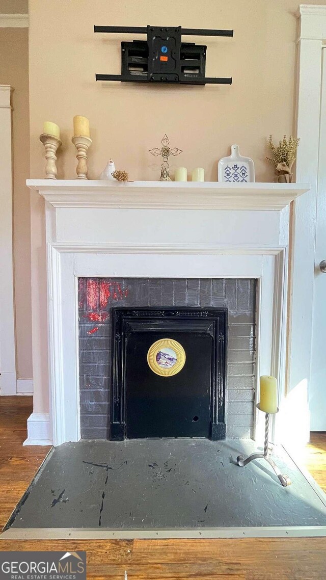 detailed view of a fireplace with flush hearth and wood finished floors