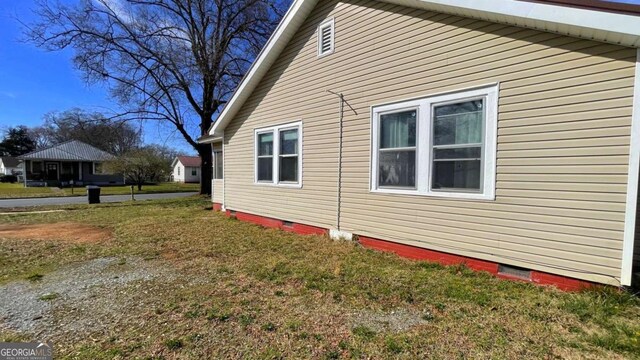 view of side of home featuring crawl space, metal roof, and entry steps